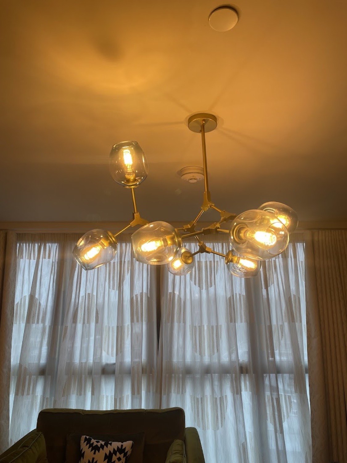 Brass cluster pendant with glass globes in a living room